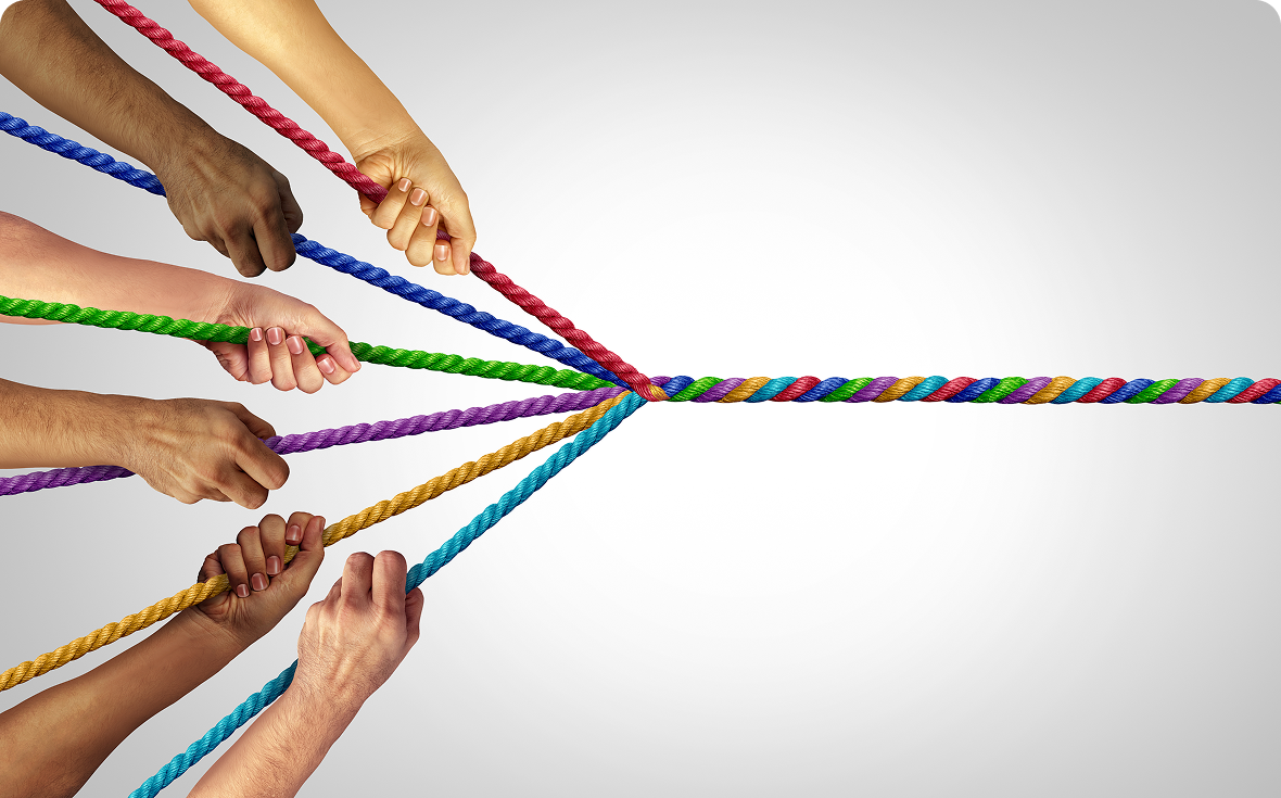 Hands pulling colorful ropes together in unity.